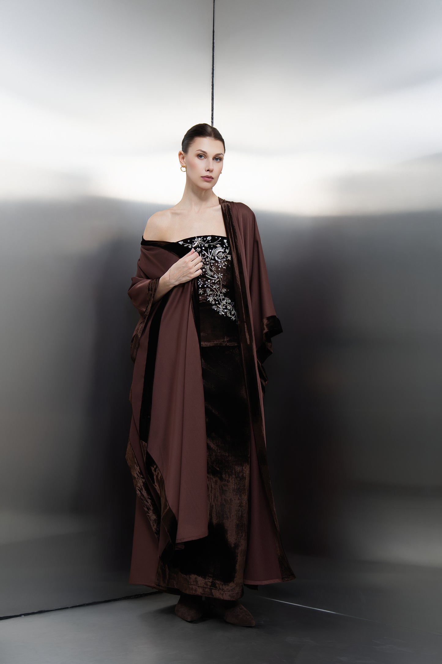 "Mona Al Shebil Brown three-piece luxury set featuring a velvet corset, matching long skirt, and a flowing crepe kimono with velvet trim for elegant evening wear.