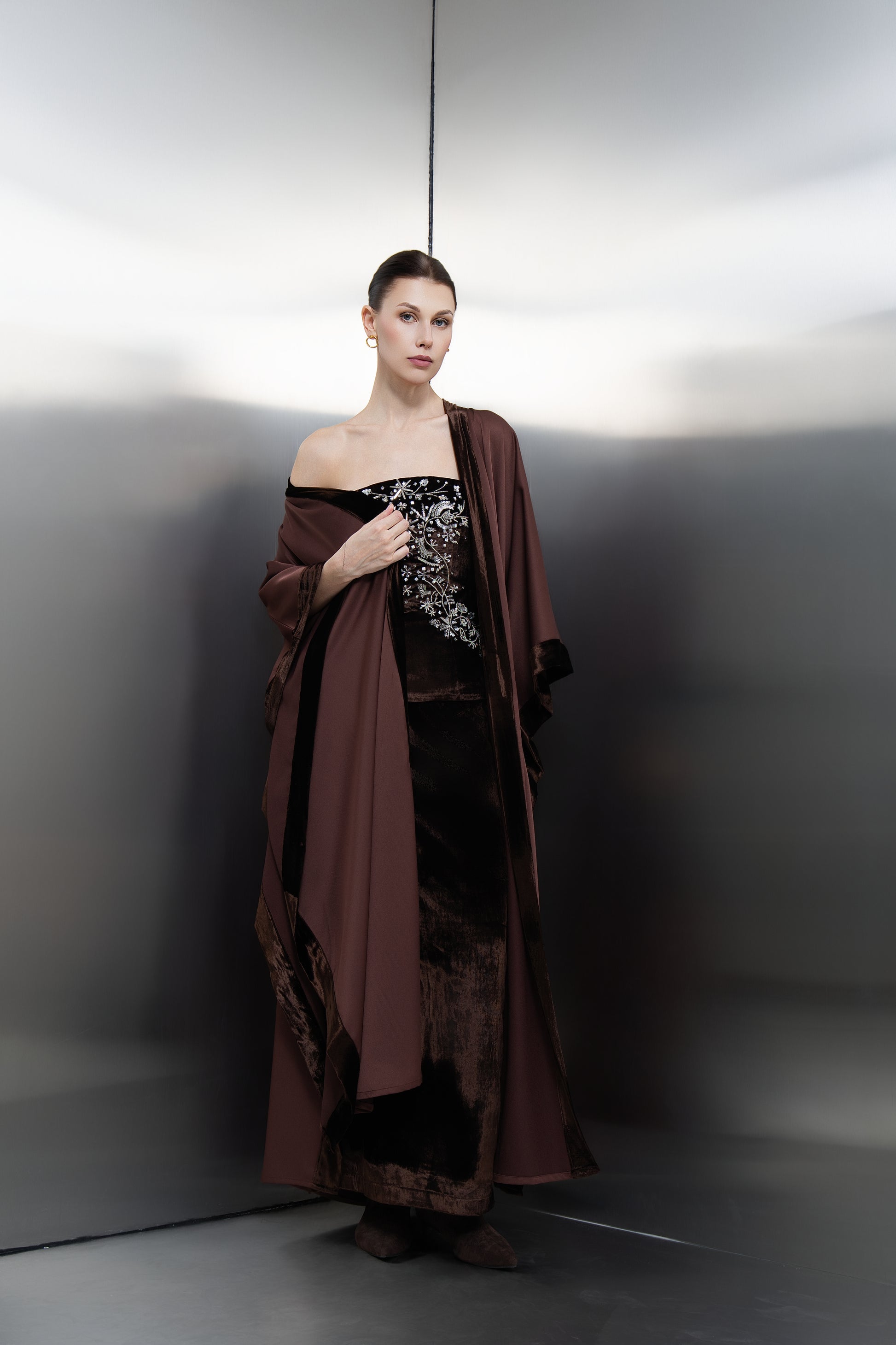 "Mona Al Shebil Brown three-piece luxury set featuring a velvet corset, matching long skirt, and a flowing crepe kimono with velvet trim for elegant evening wear.