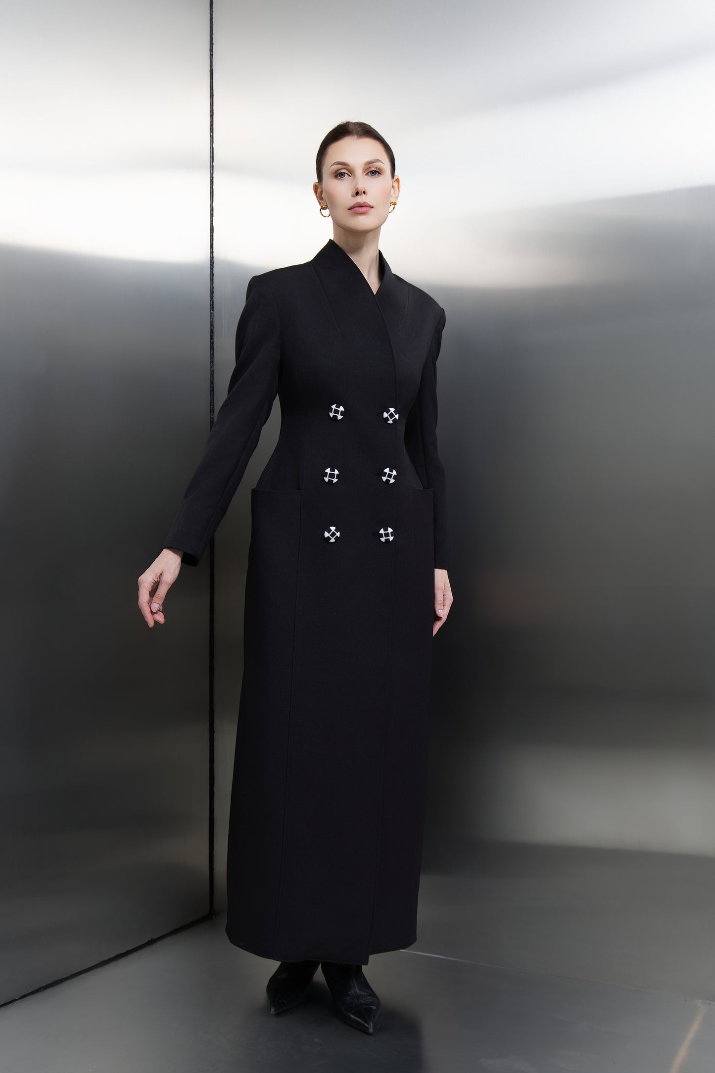 "Mona Al Shebil Black hourglass long blazer featuring a double-breasted design with unique hand-embroidered buttons, offering a powerful, tailored silhouette for the modern leader."