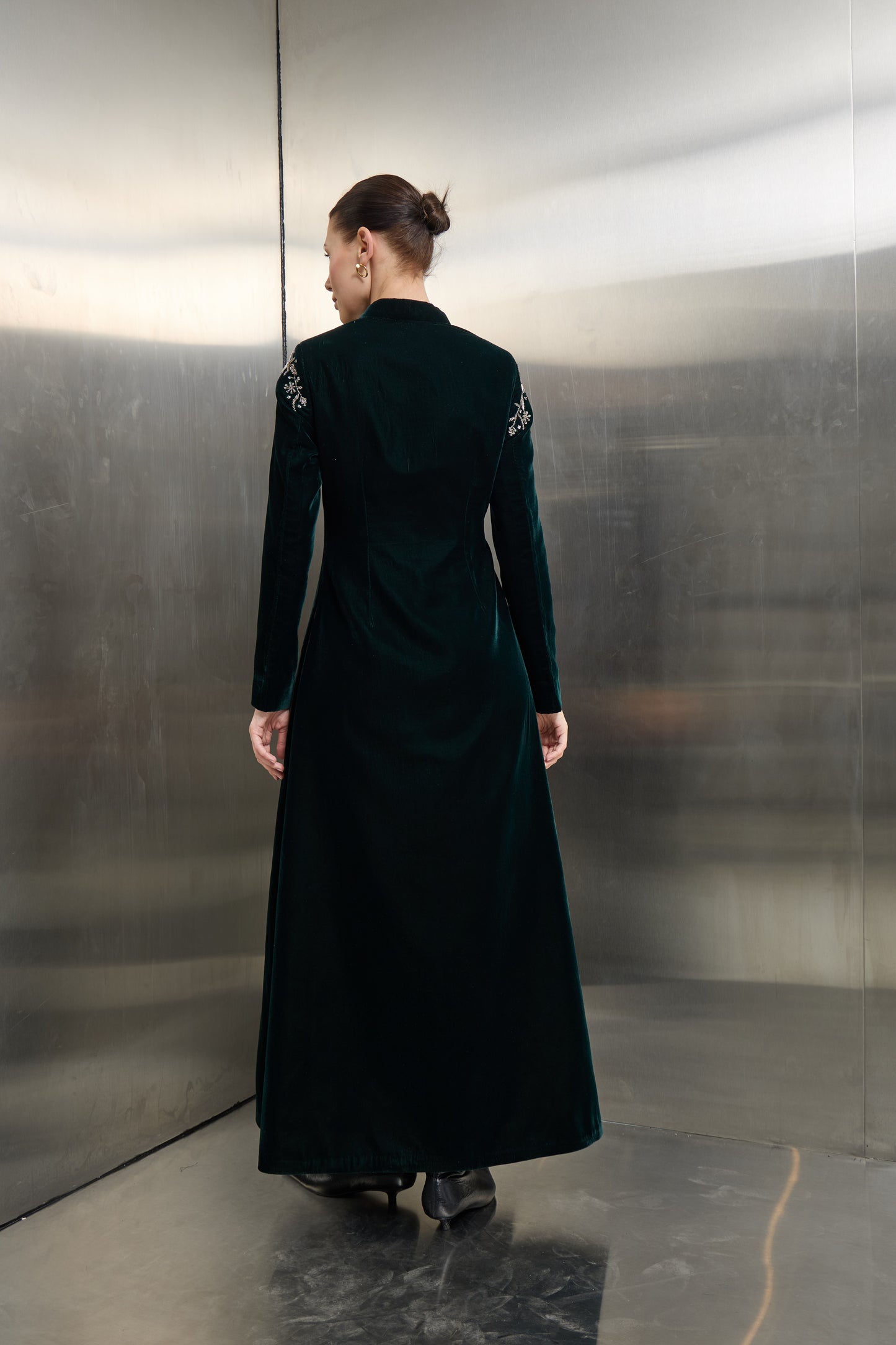 Rear view of the forest green luxury velvet jacket, emphasizing the clean lines and timeless structure designed for the modern visionary woman.
