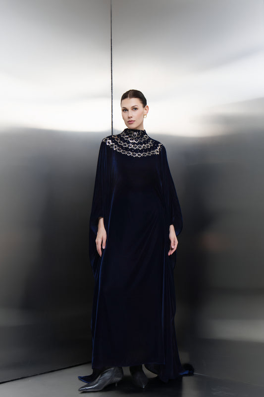 Mona Al Shebil Navy blue velvet cape kaftan with silver-stone neck embellishments, a high-end Saudi designer ready-to-wear piece for formal occasions.